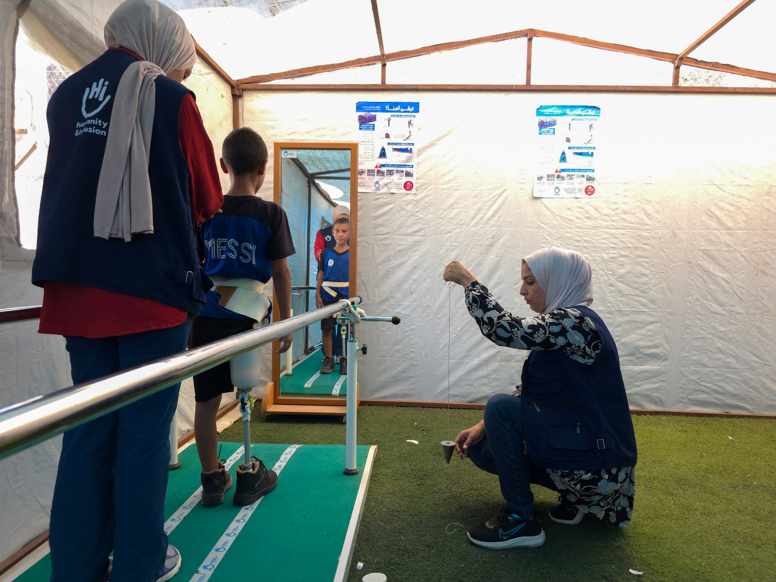 Mohammed Sameer Musleh, 10 years old, had an above-knee amputation after being hit by a tank shell. Here with P&O specialist Heba Bashir during a rehabilitation session to learn to walk with his prosthethic. 