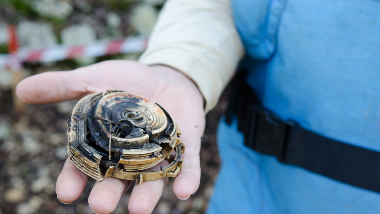 A Handicap International deminer holds part of a failed landmine. Beginning in 2010, Handicap International has been clearing explosive remnants of wars in Batroun District, North Lebanon, with the goal of having the area landmine free by 2016.